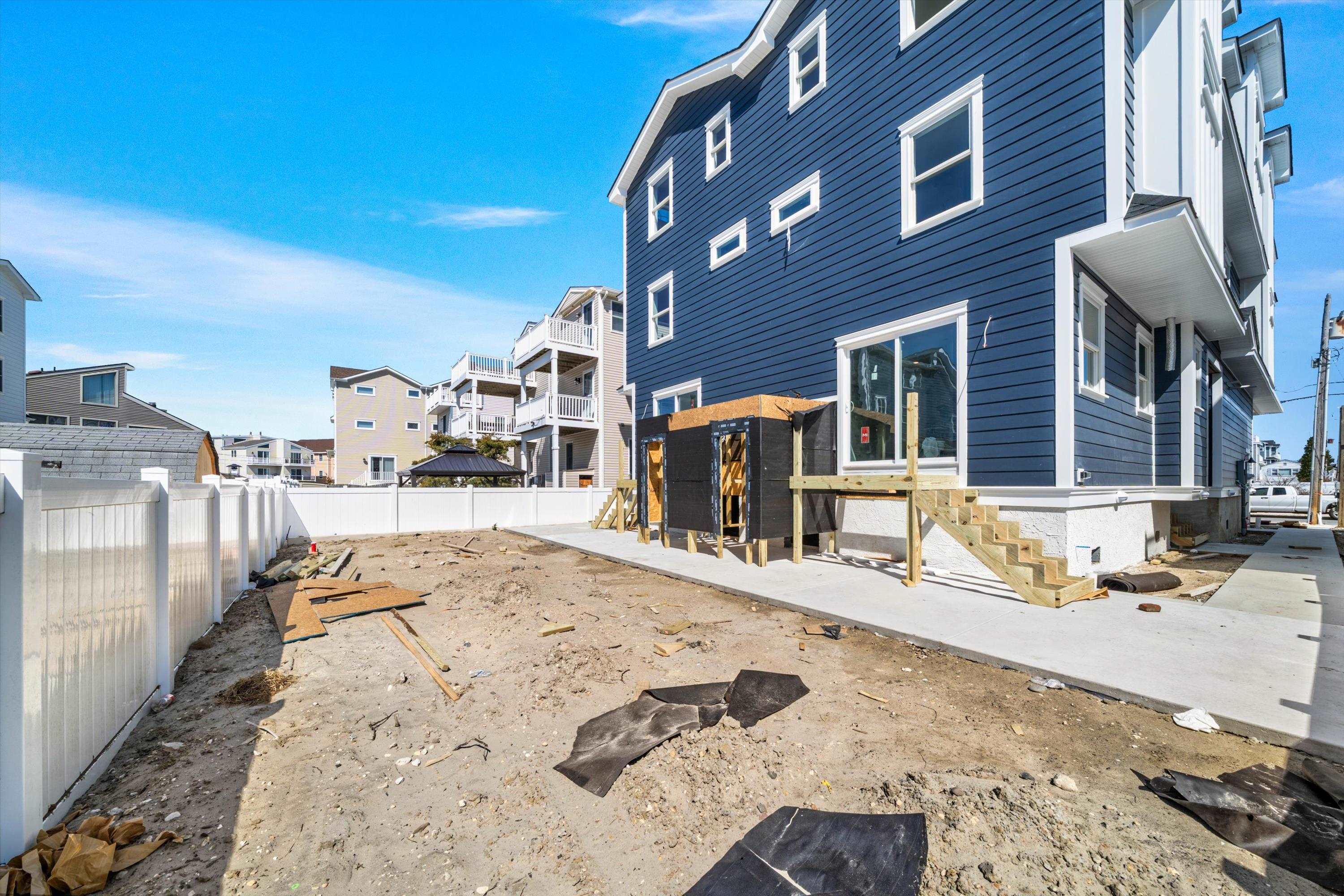 242 57th Street, Unit WEST Sea Isle City, NJ 08243 - Photo 18 of 20 a view of a house with a patio
