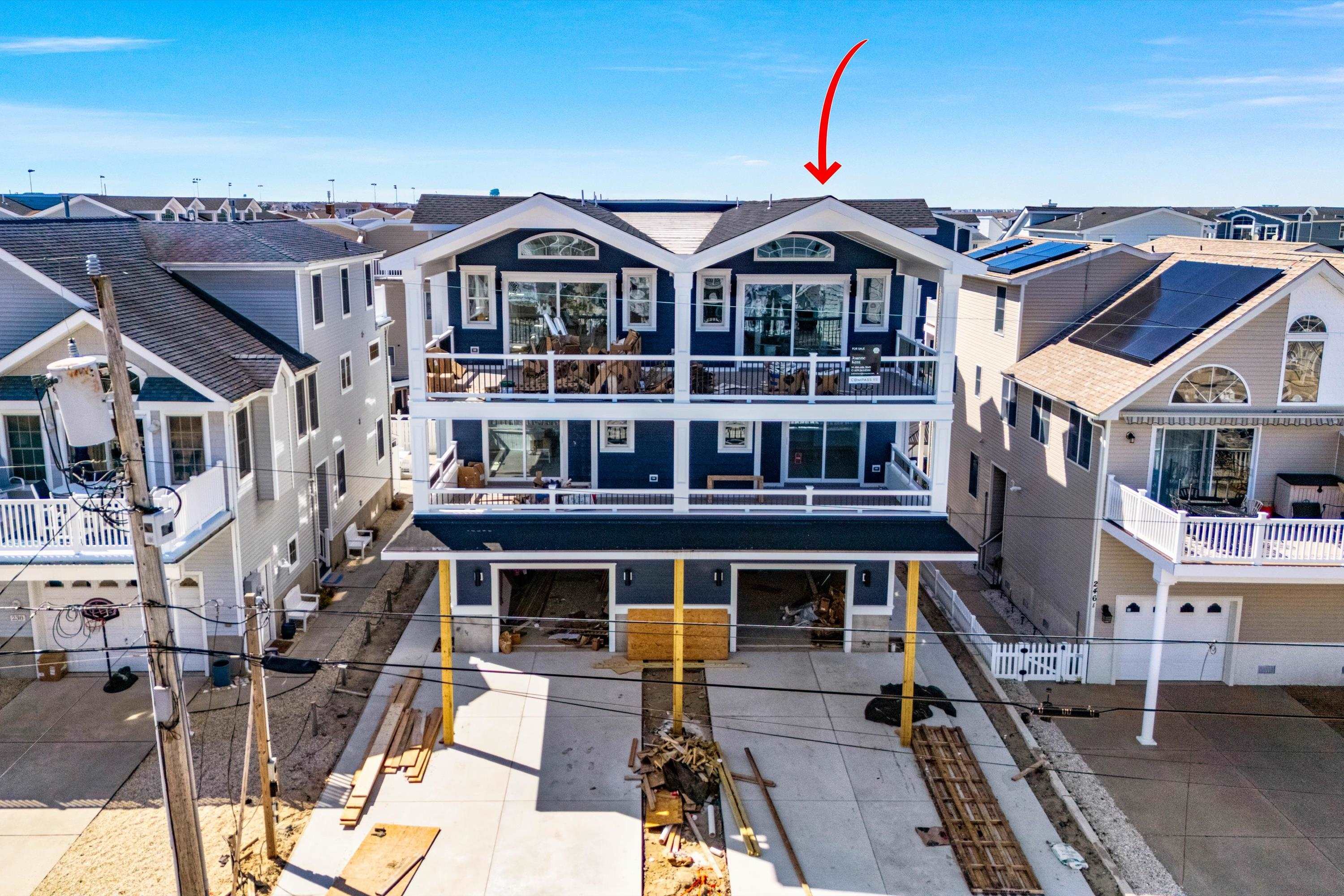 242 57th Street, Unit WEST Sea Isle City, NJ 08243 - Photo 4 of 20 a front view of a building with multiple windows