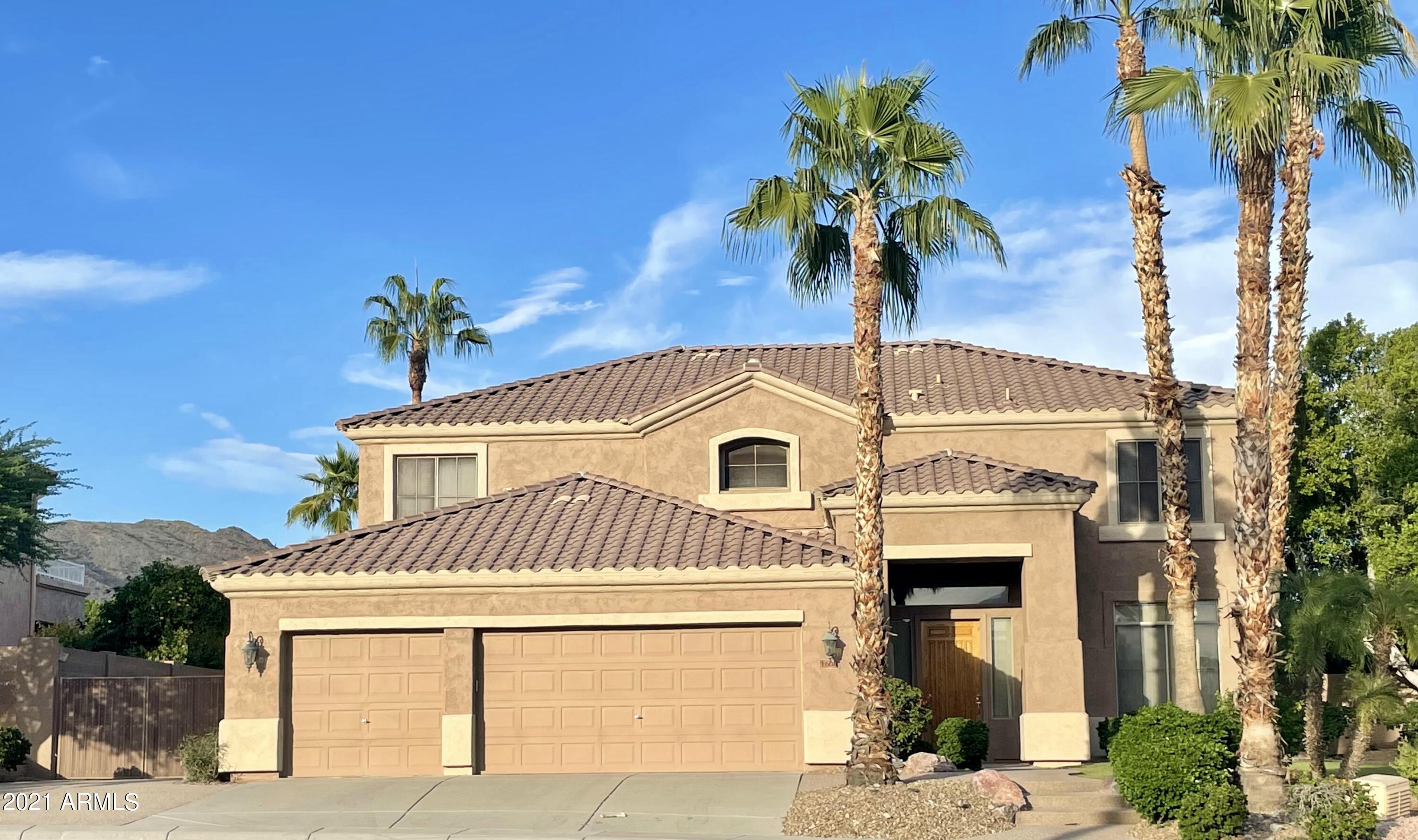 1608 West Amberwood Drive Phoenix, AZ 85045 - Photo 1 of 13 a front view of a house with a garden