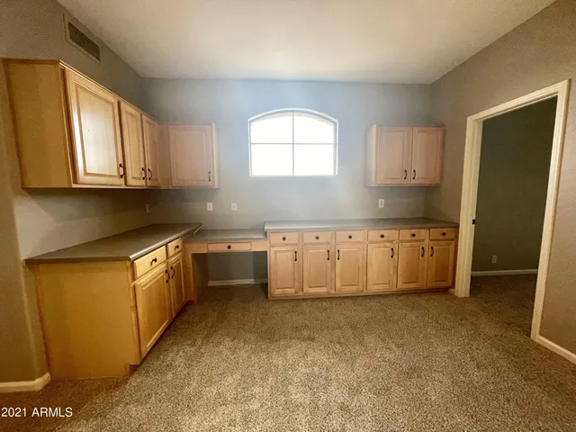 a kitchen with granite countertop a sink a window and stainless steel appliances