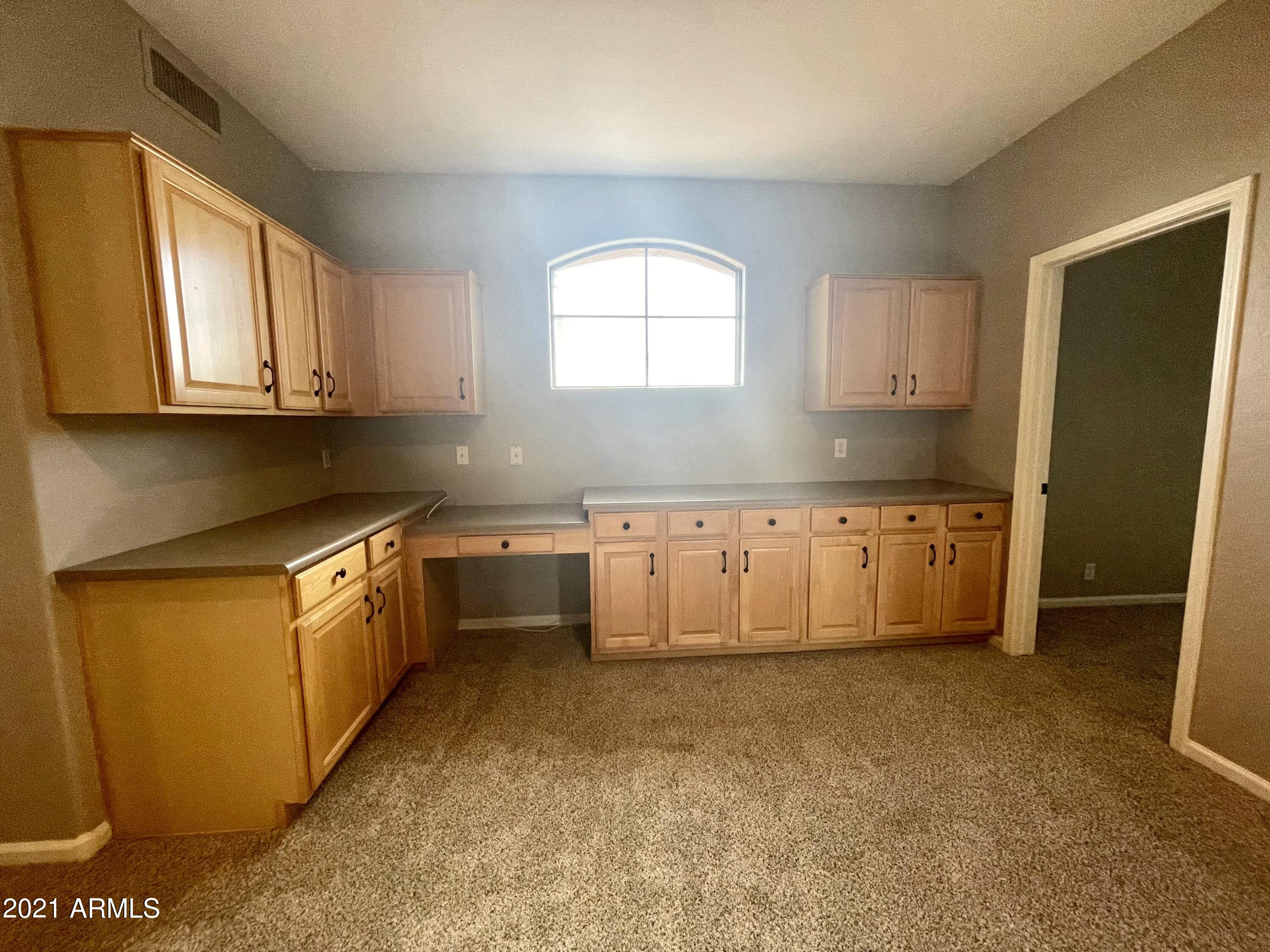 1608 West Amberwood Drive Phoenix, AZ 85045 - Photo 11 of 13 a kitchen with granite countertop a sink a window and stainless steel appliances