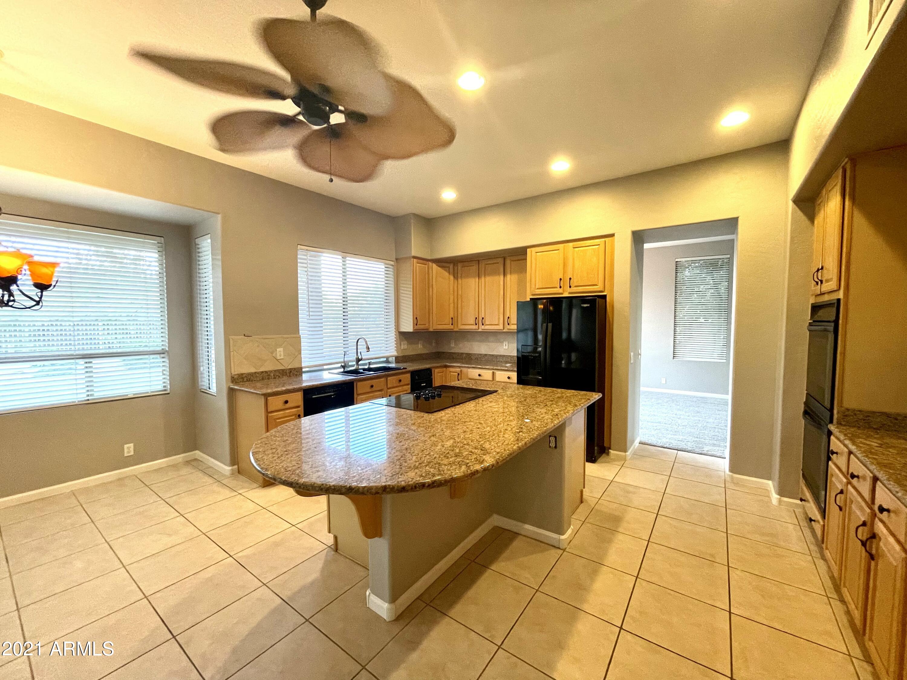 1608 West Amberwood Drive Phoenix, AZ 85045 - Photo 3 of 13 a living room with stainless steel appliances kitchen island granite countertop a refrigerator a oven a sink and a refrigerator