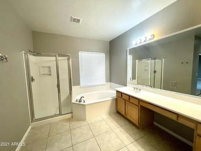 a bathroom with a tub sink and mirror