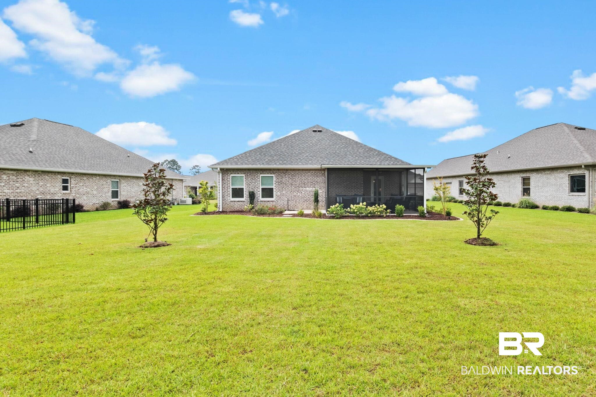 9815 Lakeview Drive Foley, AL 36535 - Photo 65 of 100 Rear view of property with a lawn and a sunroom