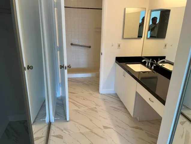 a kitchen with a sink and a refrigerator