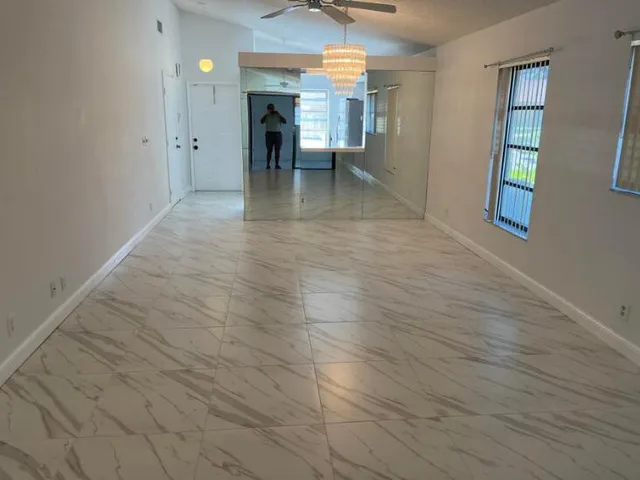 wooden floor in an empty room with a fireplace