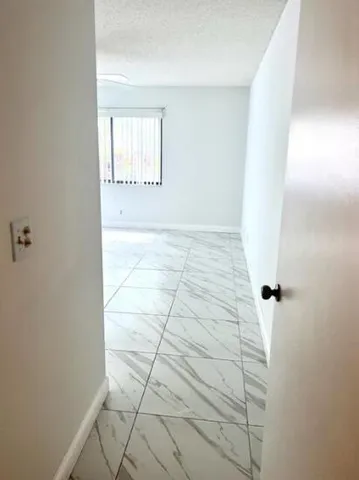 a view of a bathroom with white walls