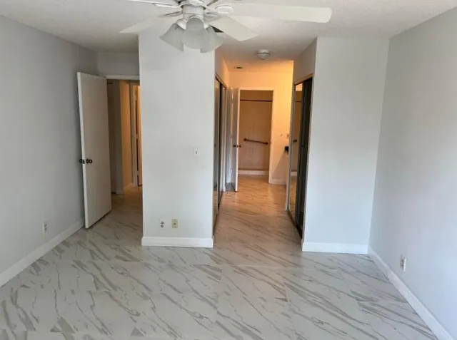 wooden floor in an empty room with a mirror