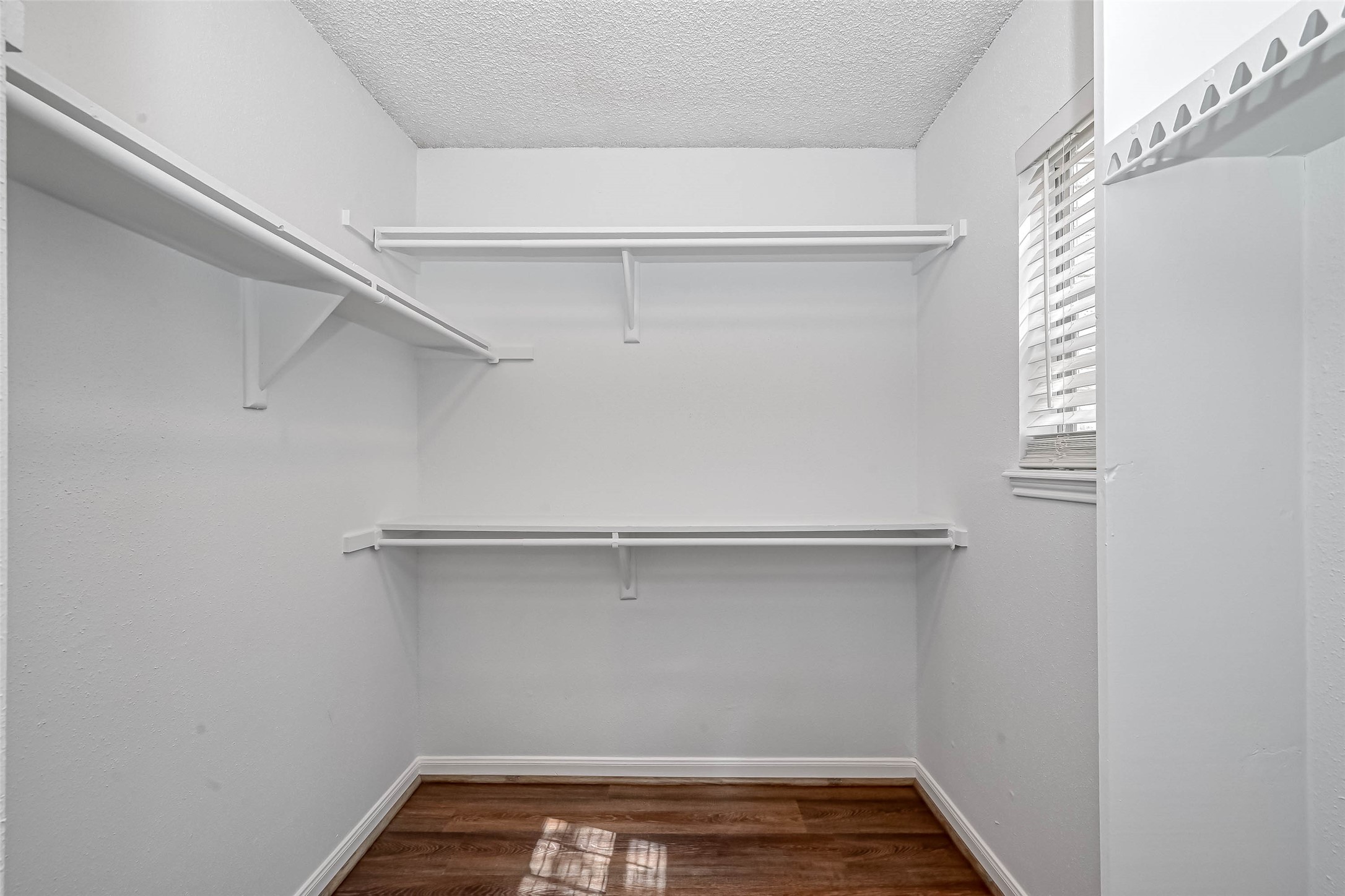 14179 Misty Meadow Lane Houston, TX 77079 - Photo 32 of 41 a view of storage and utility room with racks on the wall