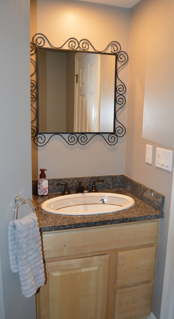 2726 East 1959th Road Ottawa, IL 61350 - Photo 19 of 31 a bathroom with a granite countertop sink and a mirror