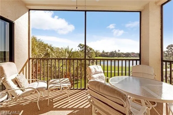 a balcony with furniture and a potted plant
