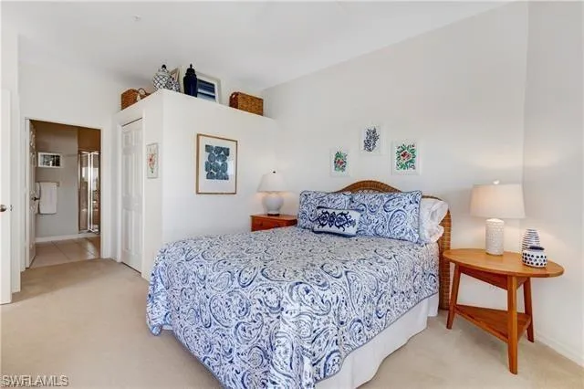 a bedroom with a bed and a dresser in it