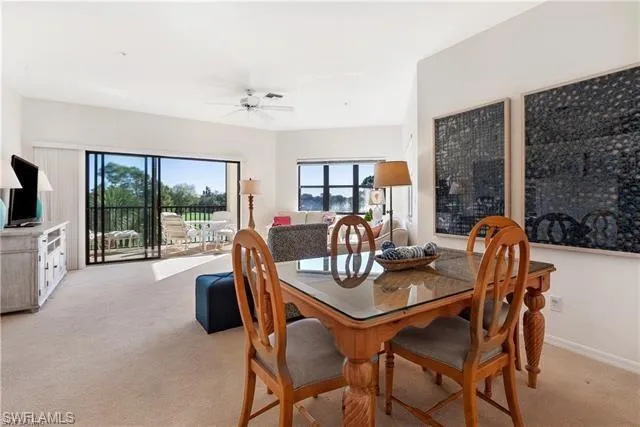 a dining room with furniture a chandelier and wooden floor