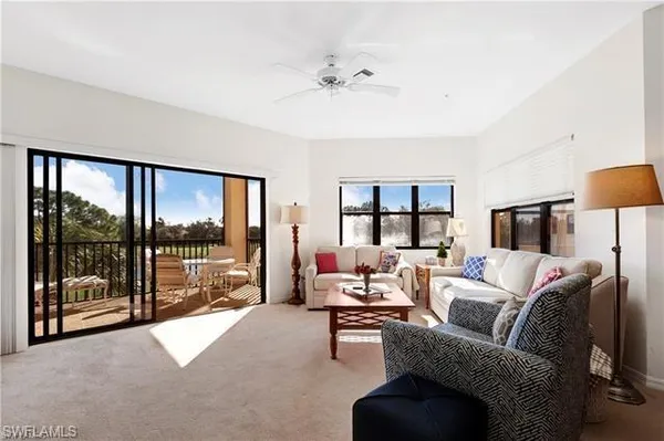 a living room with furniture and a large window