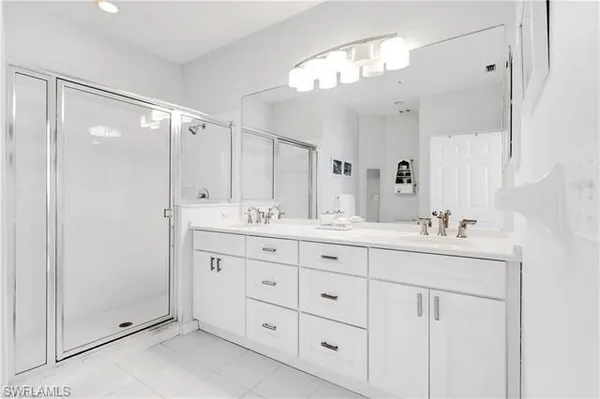 a bathroom with double sink and a mirror
