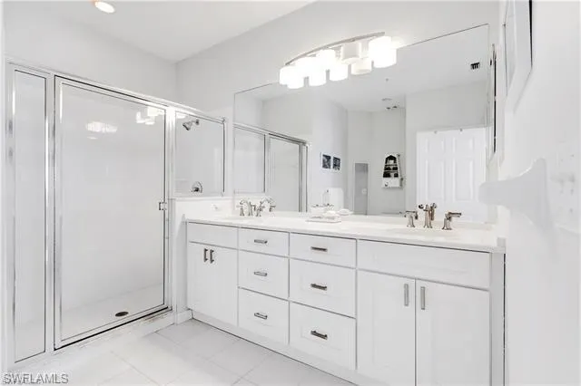 a bathroom with double sink and a mirror
