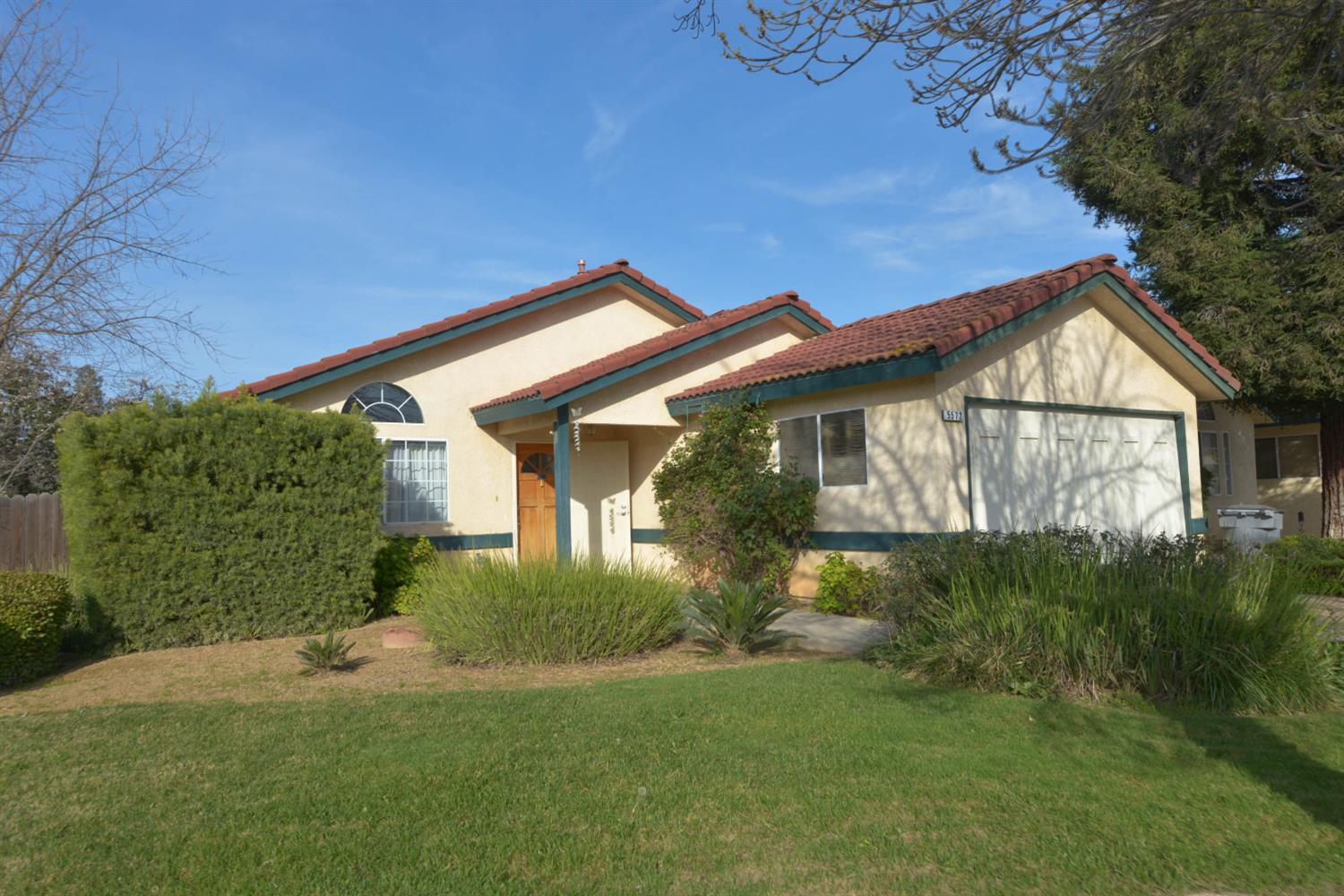 5572 West Sample Avenue Fresno, CA 93722 - Photo 1 of 42 a view of a house with a yard