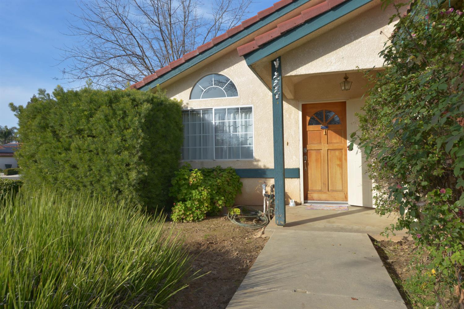 5572 West Sample Avenue Fresno, CA 93722 - Photo 11 of 42 a front view of a house with garden