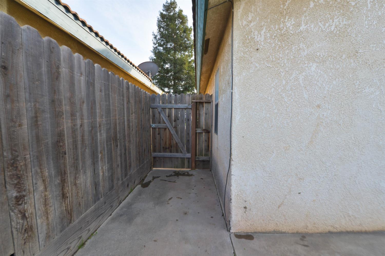 5572 West Sample Avenue Fresno, CA 93722 - Photo 18 of 42 a view of a wooden fence