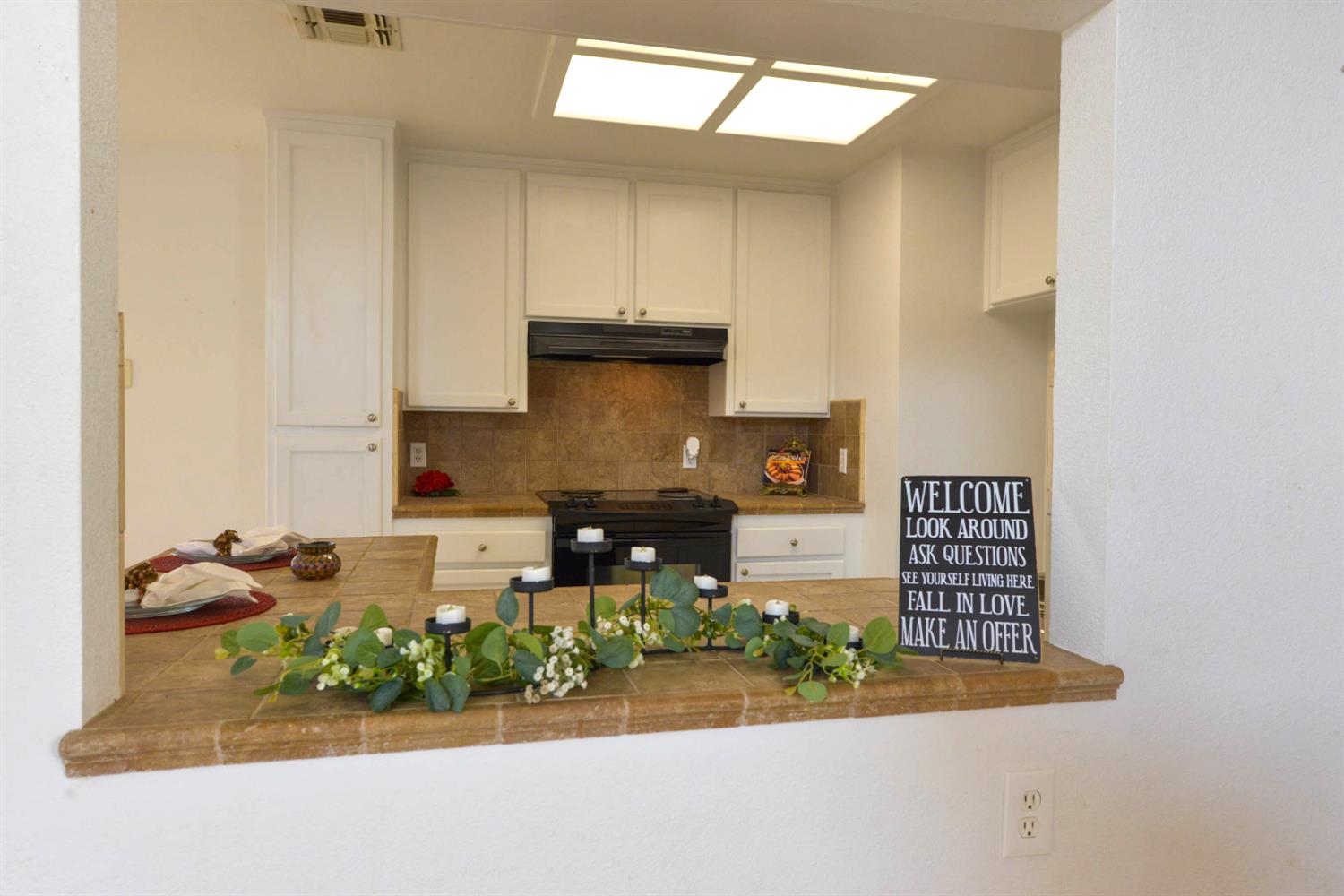 5572 West Sample Avenue Fresno, CA 93722 - Photo 25 of 42 a kitchen with stainless steel appliances granite countertop a stove a sink and a refrigerator