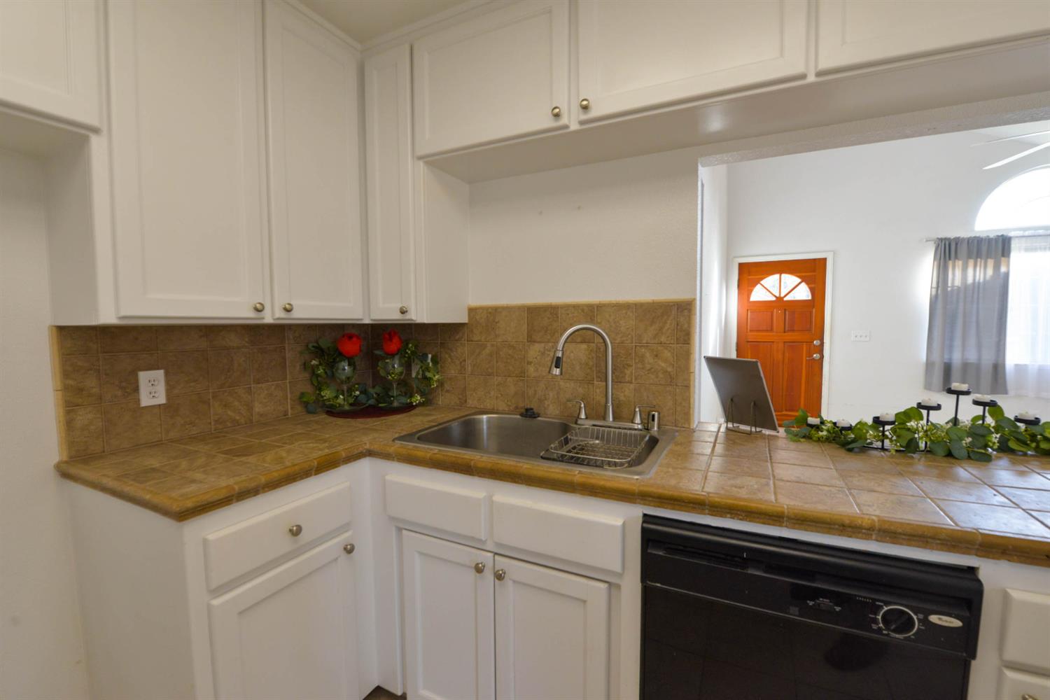 5572 West Sample Avenue Fresno, CA 93722 - Photo 29 of 42 a kitchen with stainless steel appliances granite countertop a sink and cabinets