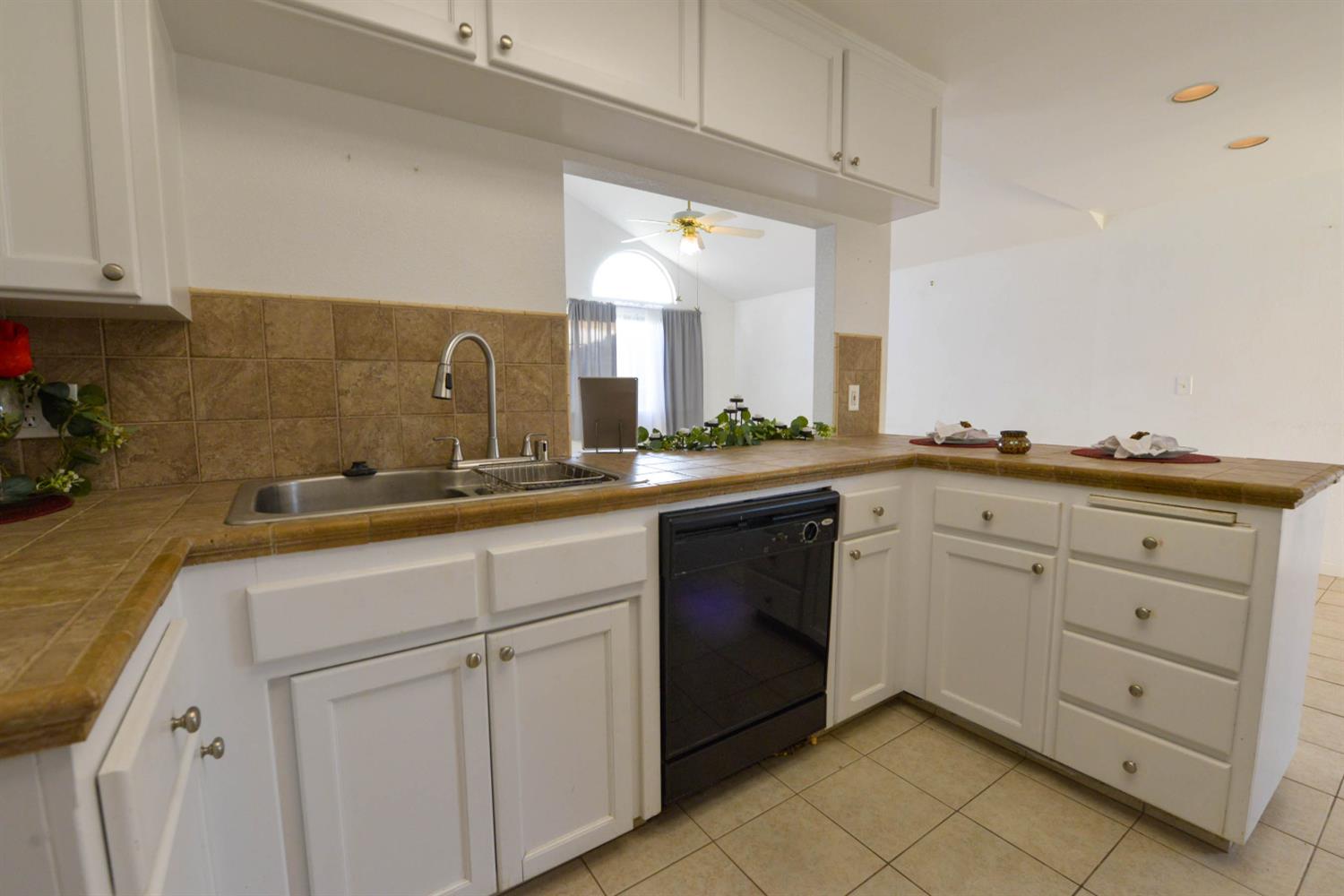 5572 West Sample Avenue Fresno, CA 93722 - Photo 30 of 42 a spacious bathroom with a granite countertop sink and a mirror