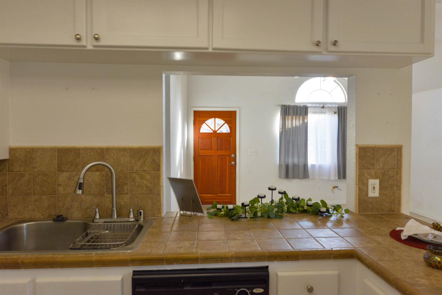 5572 West Sample Avenue Fresno, CA 93722 - Photo 31 of 42 a bathroom with sink and mirror