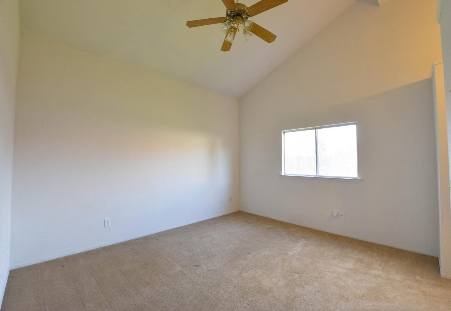 5572 West Sample Avenue Fresno, CA 93722 - Photo 33 of 42 an empty room with a window