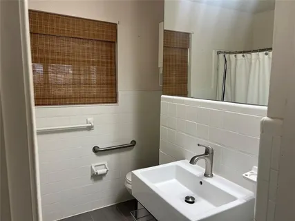 a bathroom with a sink a mirror and a toilet