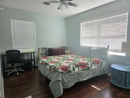 a bedroom with bed and a window