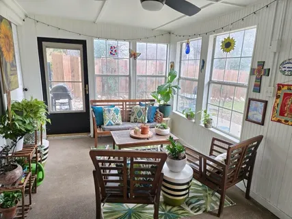 a dining room with furniture and a potted plant