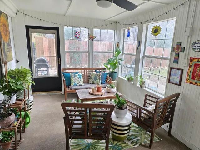 a dining room with furniture and a potted plant