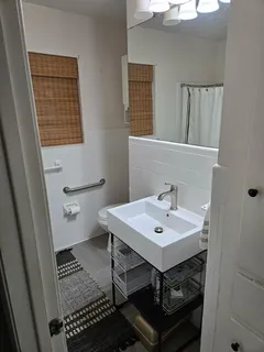 a bathroom with a sink a mirror and a toilet