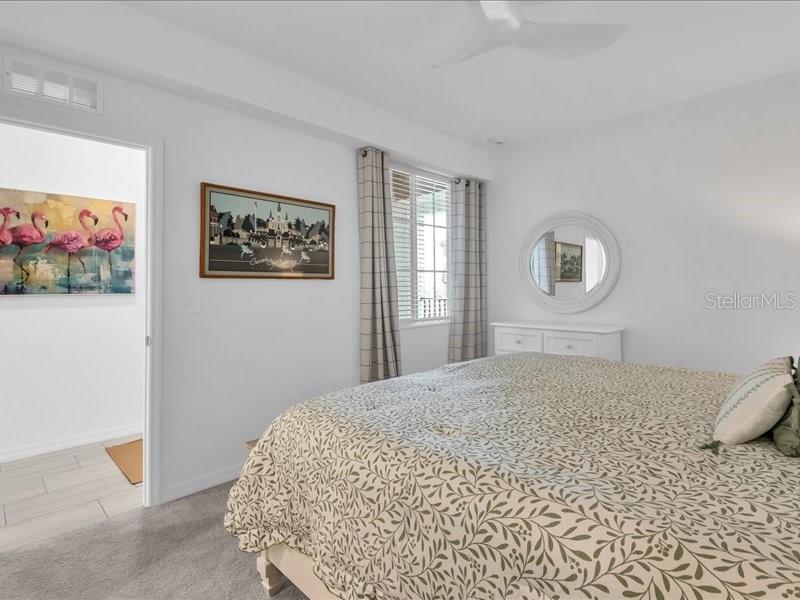 19116 Scallop Loop, Unit 303 Lakewood Ranch, FL 34211 - Photo 20 of 32 a bedroom with a bed and a painting on the wall