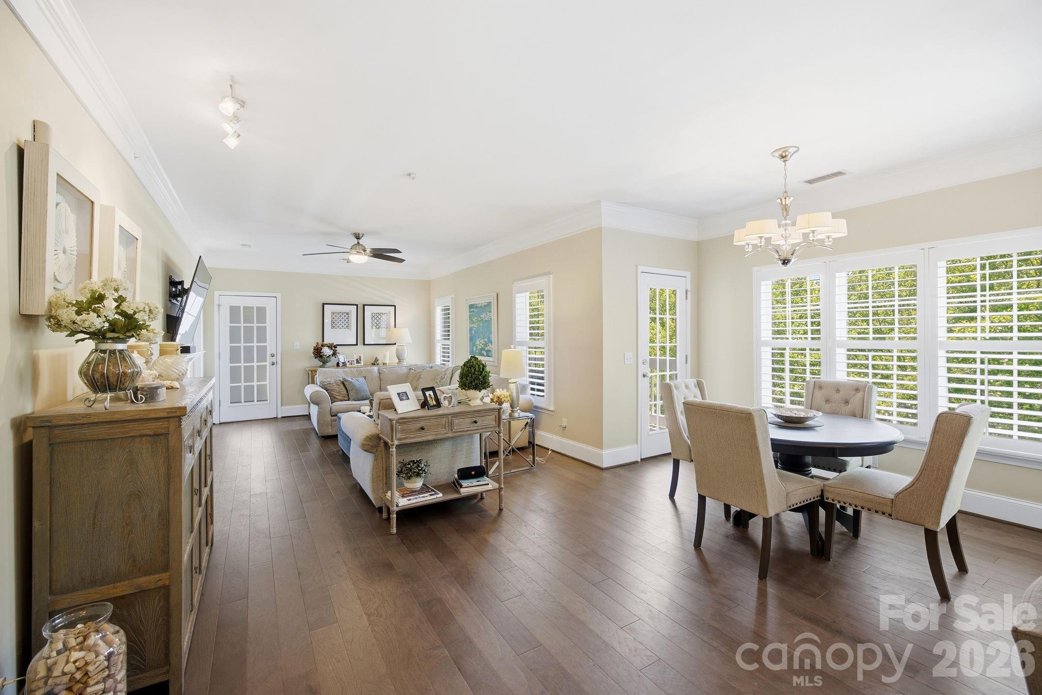 8942 Rosalyn Glen Road Cornelius, NC 28031 - Photo 13 of 47 a living room with furniture and a chandelier