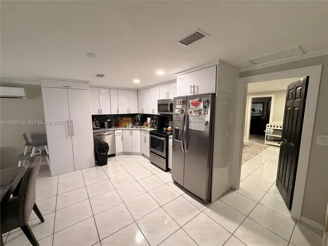 a kitchen with stainless steel appliances a refrigerator sink and cabinets
