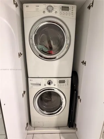 a bedroom with a bed a flat screen tv and dresser