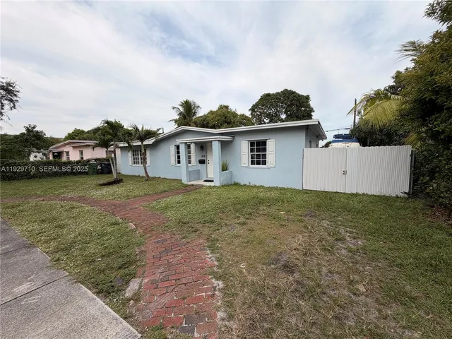 a view of a house with a yard and a garage