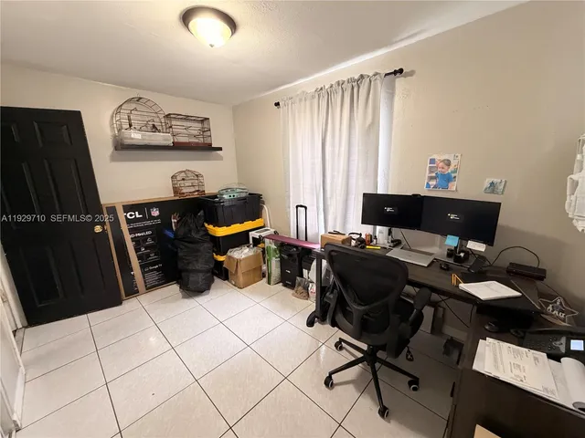 a bed room with a chair and a dresser