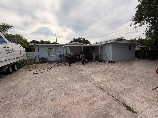 a backyard of a house with table and chairs