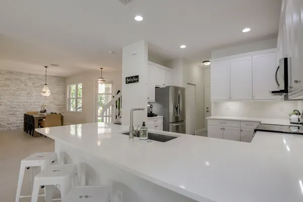 a kitchen with white cabinets and a stove top oven