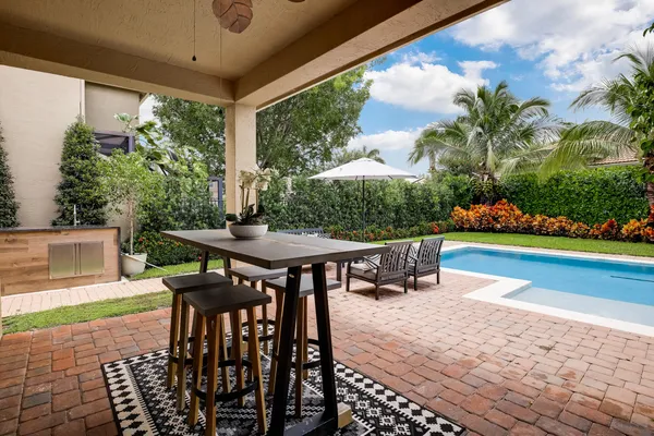 a view of a backyard with sitting area