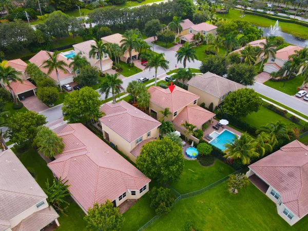 an aerial view of a house with a garden and swimming pool