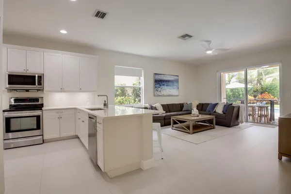 a living room with furniture and kitchen view