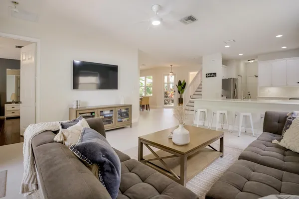 a kitchen with cabinets and chairs
