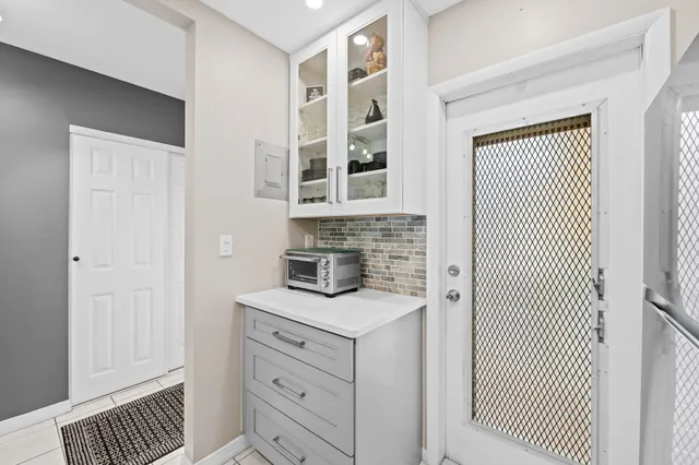 a kitchen with cabinets appliances and a window