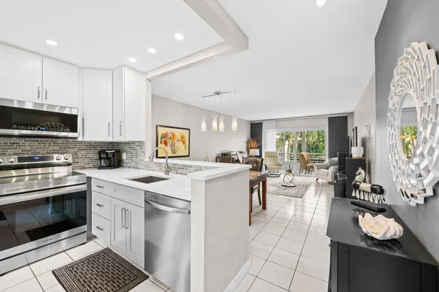 a kitchen with a sink stove and cabinets