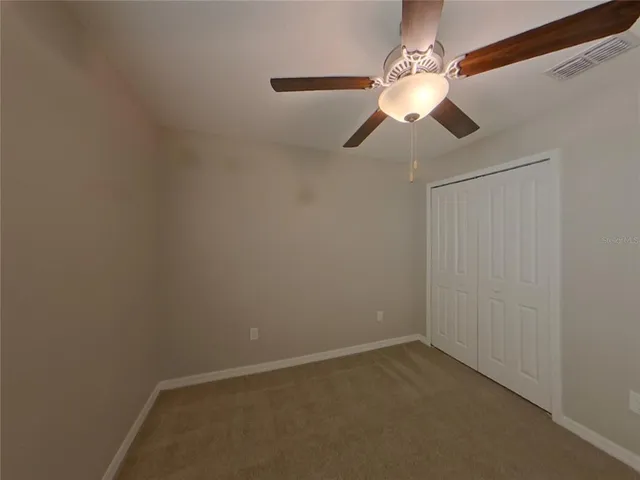 a bathroom with a granite countertop sink a toilet and a mirror