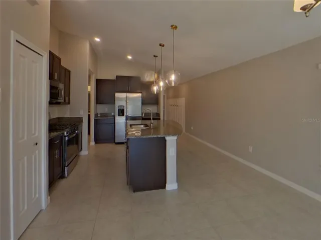 a kitchen with refrigerator and microwave