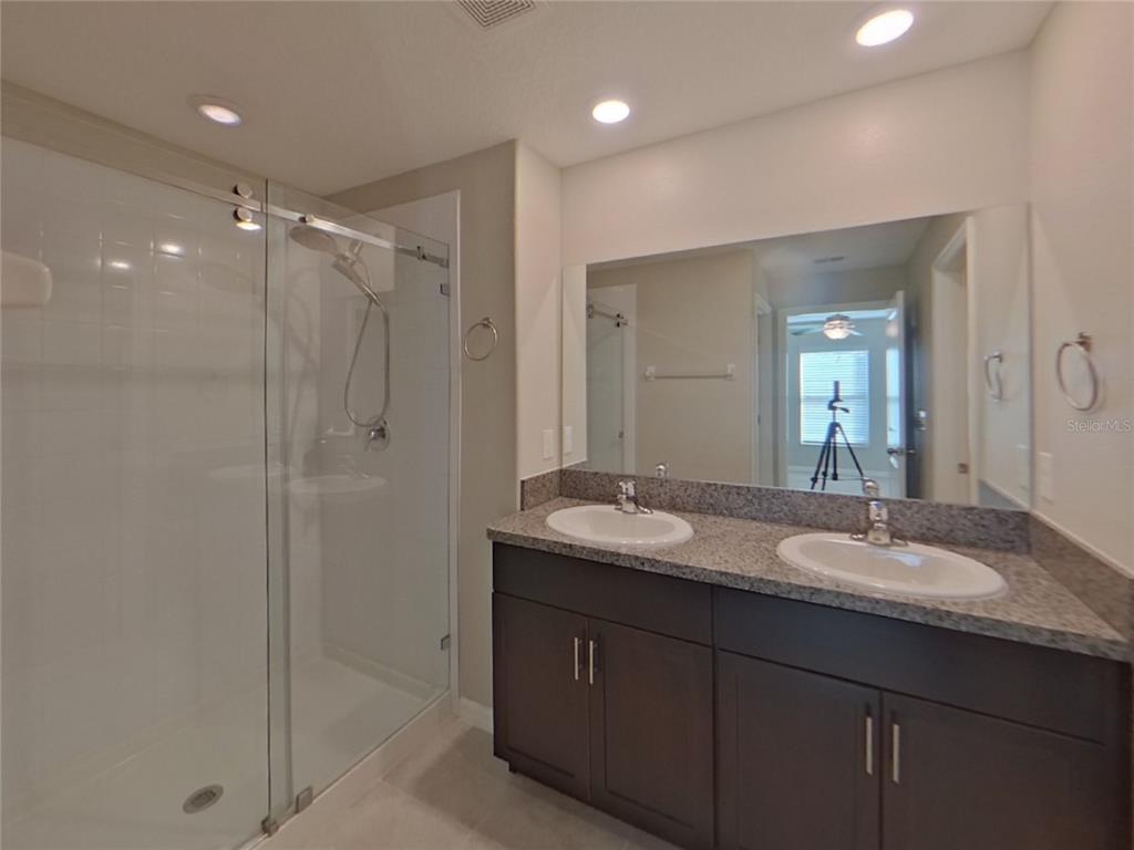 Undisclosed Address Apollo Beach, FL 33572 - Photo 7 of 15 a bathroom with double vanity sinks double vanity and a shower
